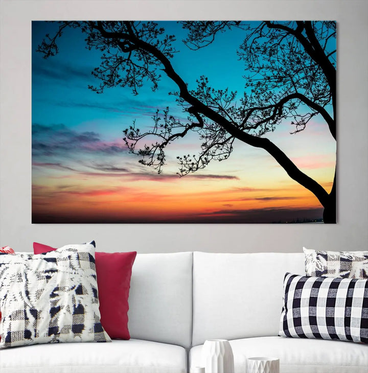 The "Sunset Tree Leaves Wall Art Canvas Print" features a triptych of tree branches against a vibrant sunset sky. Each piece is printed on museum-quality canvas and finished with a UV-protective coating, ensuring it is both stunning and ready to hang.