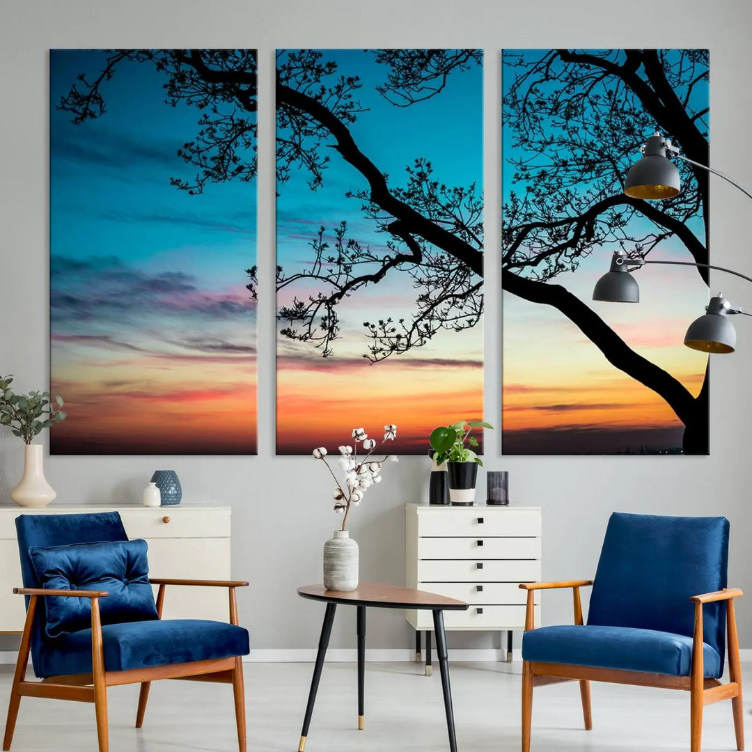 The "Sunset Tree Leaves Wall Art Canvas Print" features a triptych of tree branches against a vibrant sunset sky. Each piece is printed on museum-quality canvas and finished with a UV-protective coating, ensuring it is both stunning and ready to hang.