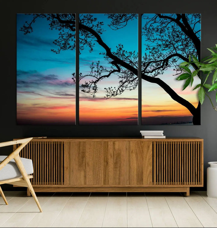 The "Sunset Tree Leaves Wall Art Canvas Print" features a triptych of tree branches against a vibrant sunset sky. Each piece is printed on museum-quality canvas and finished with a UV-protective coating, ensuring it is both stunning and ready to hang.