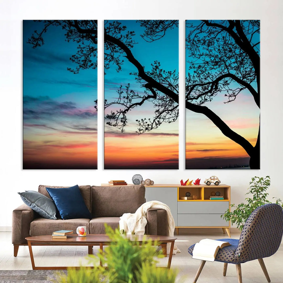 The "Sunset Tree Leaves Wall Art Canvas Print" features a triptych of tree branches against a vibrant sunset sky. Each piece is printed on museum-quality canvas and finished with a UV-protective coating, ensuring it is both stunning and ready to hang.