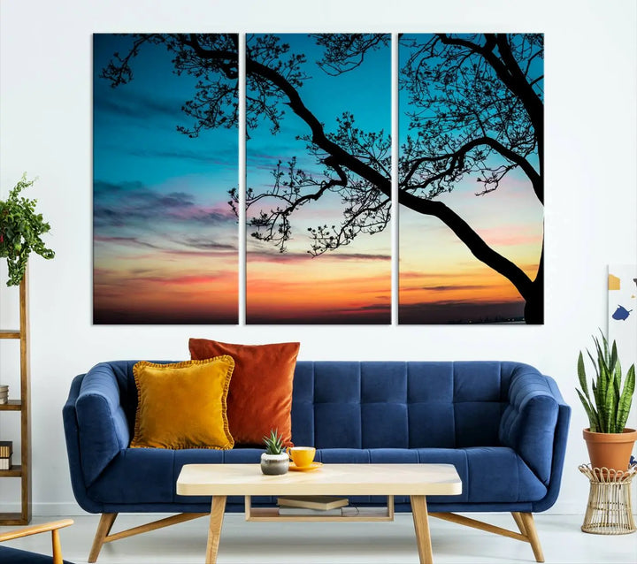 The "Sunset Tree Leaves Wall Art Canvas Print" features a triptych of tree branches against a vibrant sunset sky. Each piece is printed on museum-quality canvas and finished with a UV-protective coating, ensuring it is both stunning and ready to hang.