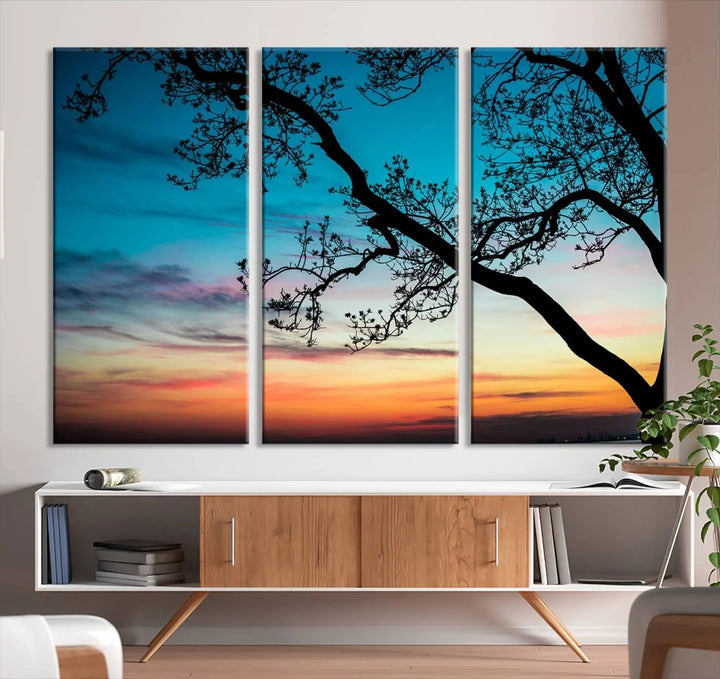 The "Sunset Tree Leaves Wall Art Canvas Print" features a triptych of tree branches against a vibrant sunset sky. Each piece is printed on museum-quality canvas and finished with a UV-protective coating, ensuring it is both stunning and ready to hang.