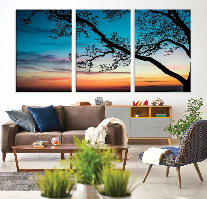 The "Sunset Tree Leaves Wall Art Canvas Print" features a triptych of tree branches against a vibrant sunset sky. Each piece is printed on museum-quality canvas and finished with a UV-protective coating, ensuring it is both stunning and ready to hang.