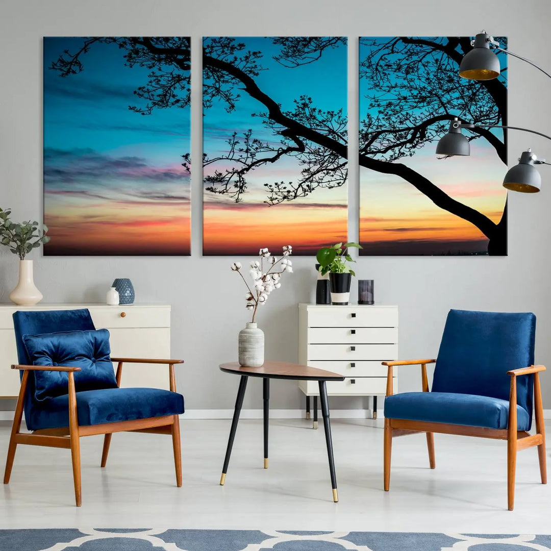 The "Sunset Tree Leaves Wall Art Canvas Print" features a triptych of tree branches against a vibrant sunset sky. Each piece is printed on museum-quality canvas and finished with a UV-protective coating, ensuring it is both stunning and ready to hang.