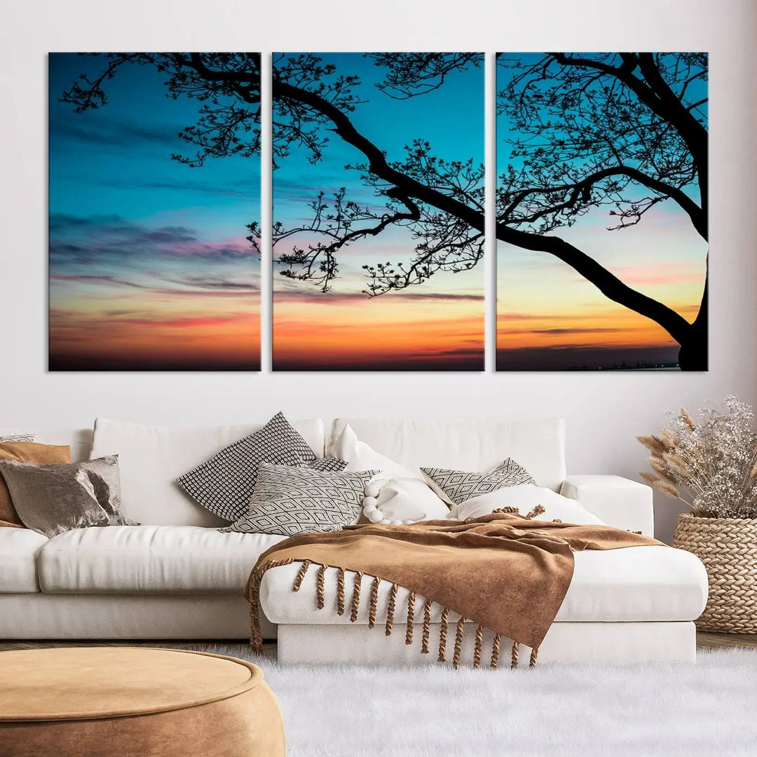 The "Sunset Tree Leaves Wall Art Canvas Print" features a triptych of tree branches against a vibrant sunset sky. Each piece is printed on museum-quality canvas and finished with a UV-protective coating, ensuring it is both stunning and ready to hang.