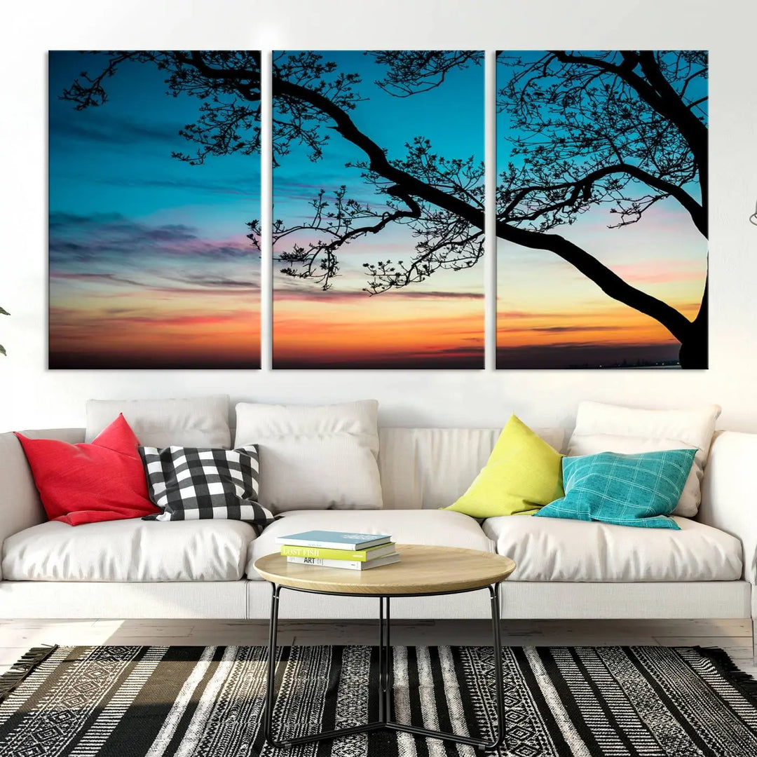 The "Sunset Tree Leaves Wall Art Canvas Print" features a triptych of tree branches against a vibrant sunset sky. Each piece is printed on museum-quality canvas and finished with a UV-protective coating, ensuring it is both stunning and ready to hang.