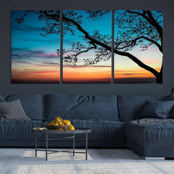 The "Sunset Tree Leaves Wall Art Canvas Print" features a triptych of tree branches against a vibrant sunset sky. Each piece is printed on museum-quality canvas and finished with a UV-protective coating, ensuring it is both stunning and ready to hang.