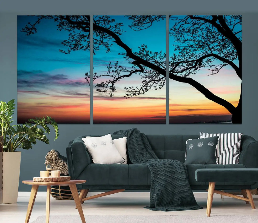 The "Sunset Tree Leaves Wall Art Canvas Print" features a triptych of tree branches against a vibrant sunset sky. Each piece is printed on museum-quality canvas and finished with a UV-protective coating, ensuring it is both stunning and ready to hang.