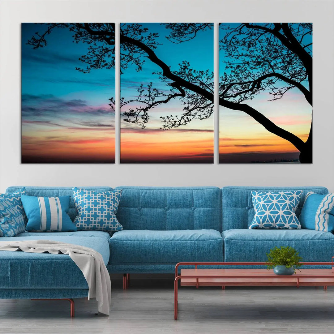 The "Sunset Tree Leaves Wall Art Canvas Print" features a triptych of tree branches against a vibrant sunset sky. Each piece is printed on museum-quality canvas and finished with a UV-protective coating, ensuring it is both stunning and ready to hang.