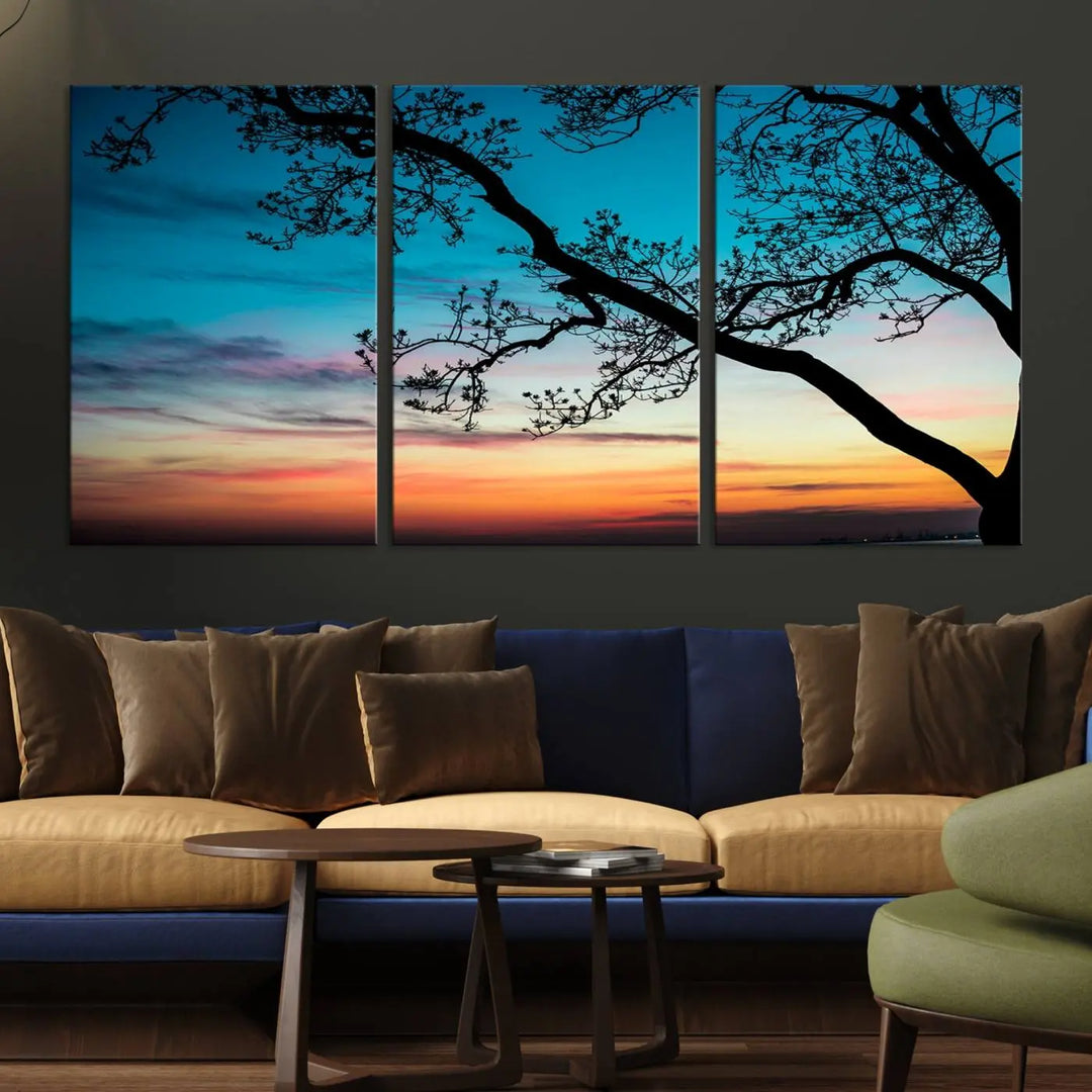 The "Sunset Tree Leaves Wall Art Canvas Print" features a triptych of tree branches against a vibrant sunset sky. Each piece is printed on museum-quality canvas and finished with a UV-protective coating, ensuring it is both stunning and ready to hang.