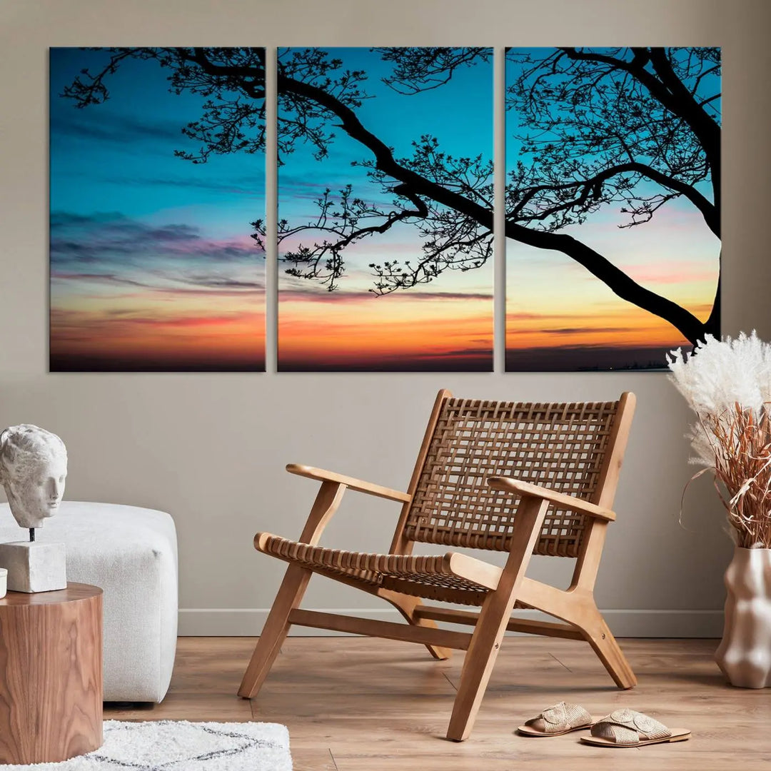 The "Sunset Tree Leaves Wall Art Canvas Print" features a triptych of tree branches against a vibrant sunset sky. Each piece is printed on museum-quality canvas and finished with a UV-protective coating, ensuring it is both stunning and ready to hang.