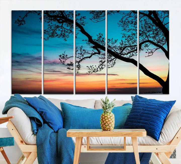 The "Sunset Tree Leaves Wall Art Canvas Print" features a triptych of tree branches against a vibrant sunset sky. Each piece is printed on museum-quality canvas and finished with a UV-protective coating, ensuring it is both stunning and ready to hang.