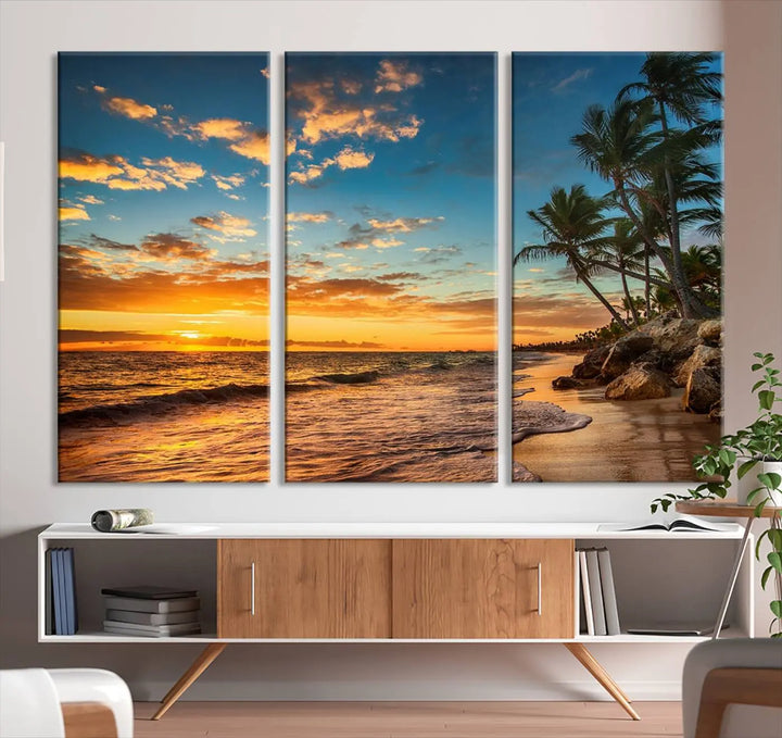 The Sunset Wall Art Canvas Print beautifully enhances the living room. This tropical triptych, crafted on museum-quality canvas, depicts a sunset with palm trees and adds a touch of paradise to the space. Enjoy the charm of hand-assembled frames with free shipping included.