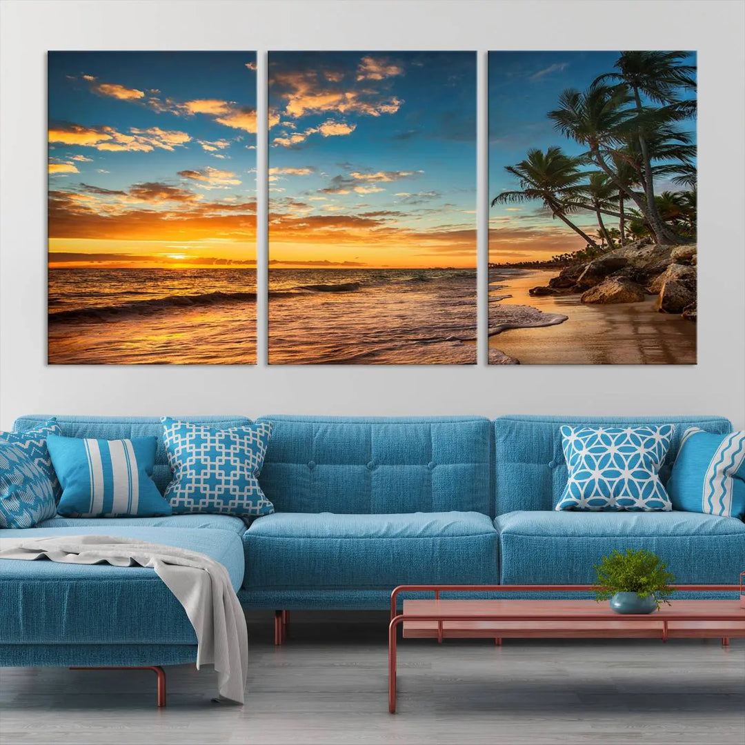 The Sunset Wall Art Canvas Print beautifully enhances the living room. This tropical triptych, crafted on museum-quality canvas, depicts a sunset with palm trees and adds a touch of paradise to the space. Enjoy the charm of hand-assembled frames with free shipping included.