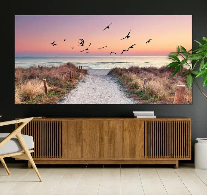 The wall art, titled "Sunset and Ocean Wall Art Canvas Print," is a museum-quality piece depicting a beach path at sunset with birds in flight.