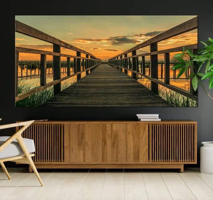 The "Sunset and Wood Bridge" triptych, printed on museum-quality canvases with a UV-protective coating, adorns the wall.