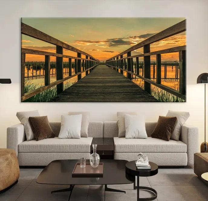 The "Sunset and Wood Bridge" triptych, printed on museum-quality canvases with a UV-protective coating, adorns the wall.