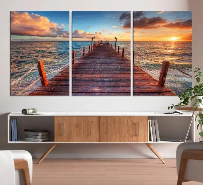 A gallery-wrapped triptych of the "Sunset and Wood Pier Wall Art Canvas Print" is expertly printed on museum-quality canvas with a UV-protective coating.