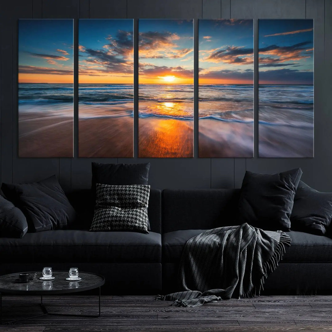 The Sunset on Beach Canvas Wall Art Canvas Print is a triptych depicting a sunset over the ocean. Each piece of this museum-quality polycotton canvas is gallery wrapped and has a UV-protective coating to maintain its vibrant colors. It is displayed on a living room wall.