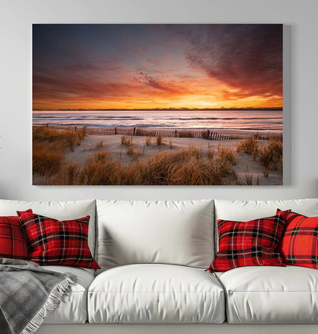 Sunset on The Beach Wall Art Canvas Print features a triptych of a beach at sunset with vivid orange skies, presented on museum-quality canvas. Each section is gallery wrapped, offering lasting beauty with its UV-protective coating.