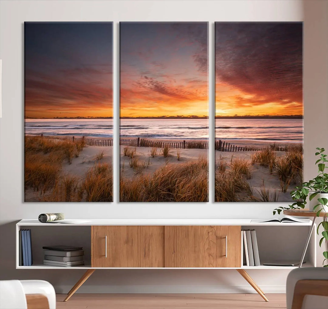 Sunset on The Beach Wall Art Canvas Print features a triptych of a beach at sunset with vivid orange skies, presented on museum-quality canvas. Each section is gallery wrapped, offering lasting beauty with its UV-protective coating.