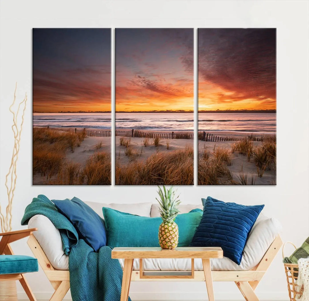 Sunset on The Beach Wall Art Canvas Print features a triptych of a beach at sunset with vivid orange skies, presented on museum-quality canvas. Each section is gallery wrapped, offering lasting beauty with its UV-protective coating.