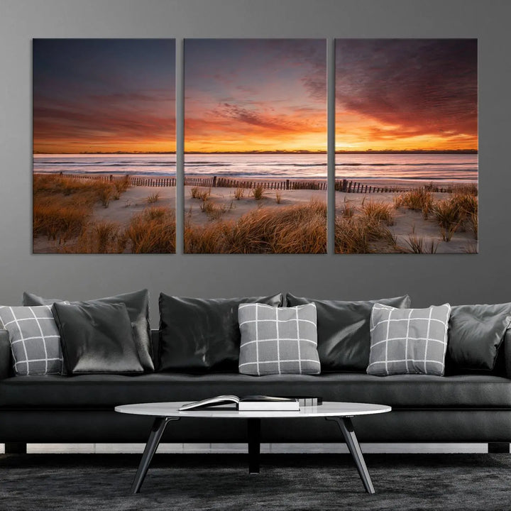 Sunset on The Beach Wall Art Canvas Print features a triptych of a beach at sunset with vivid orange skies, presented on museum-quality canvas. Each section is gallery wrapped, offering lasting beauty with its UV-protective coating.