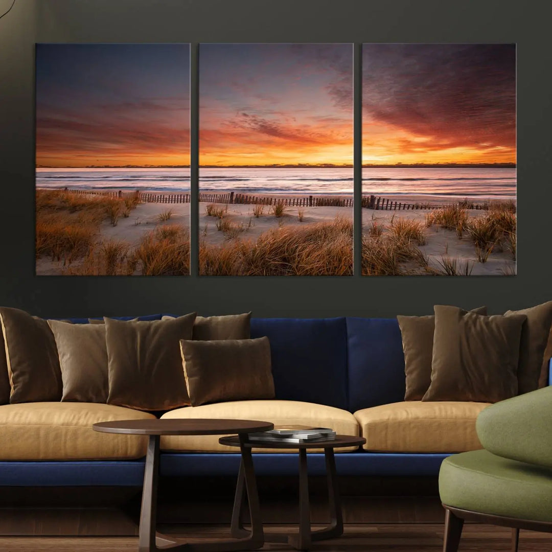 Sunset on The Beach Wall Art Canvas Print features a triptych of a beach at sunset with vivid orange skies, presented on museum-quality canvas. Each section is gallery wrapped, offering lasting beauty with its UV-protective coating.