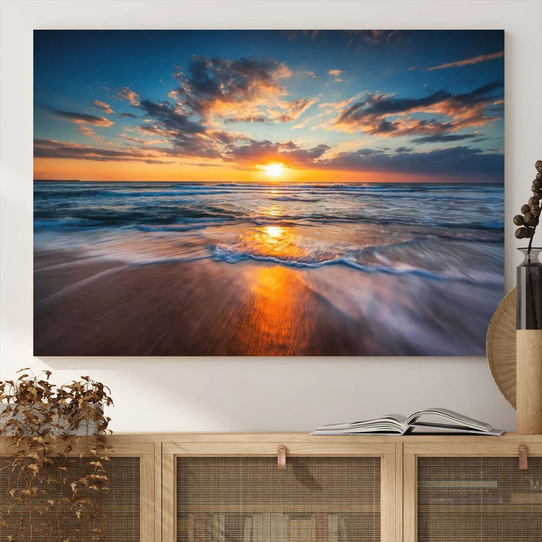 A triptych of "Sunset on the Ocean Beach with Waves," a vibrant coastal wall art print, showcases reflections on the sand during an ocean sunset.