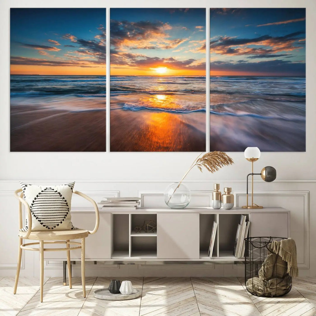 A triptych of "Sunset on the Ocean Beach with Waves," a vibrant coastal wall art print, showcases reflections on the sand during an ocean sunset.