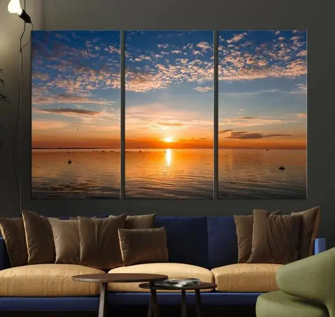 The "Sunset on the Sea Wall Art Canvas Print" graces the space as a stunning triptych, with its museum-quality canvas showcasing a serene sunset over water. The gallery-wrapped edges enhance depth and elegance, creating an ideal centerpiece for any room.