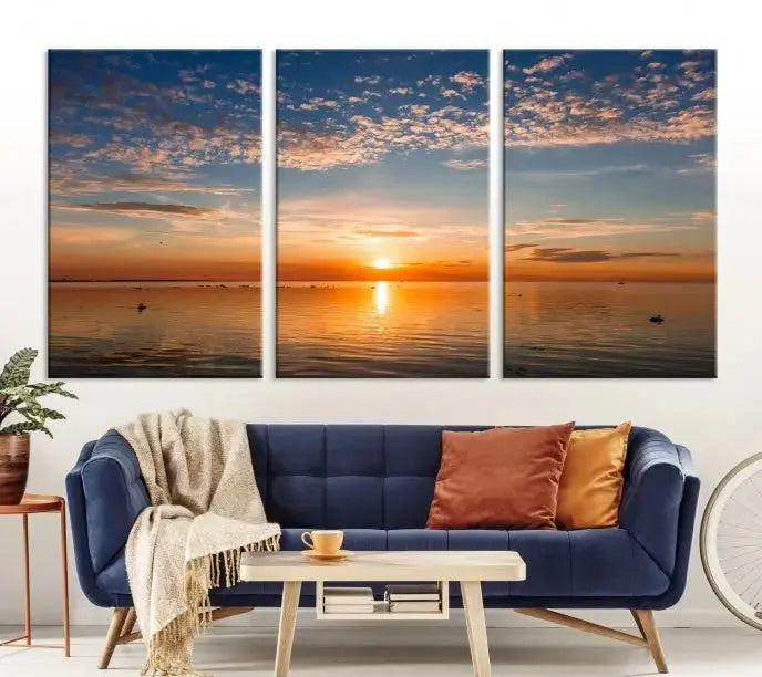 The "Sunset on the Sea Wall Art Canvas Print" graces the space as a stunning triptych, with its museum-quality canvas showcasing a serene sunset over water. The gallery-wrapped edges enhance depth and elegance, creating an ideal centerpiece for any room.