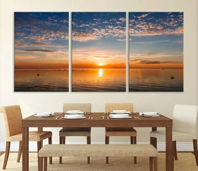 The "Sunset on the Sea Wall Art Canvas Print" graces the space as a stunning triptych, with its museum-quality canvas showcasing a serene sunset over water. The gallery-wrapped edges enhance depth and elegance, creating an ideal centerpiece for any room.