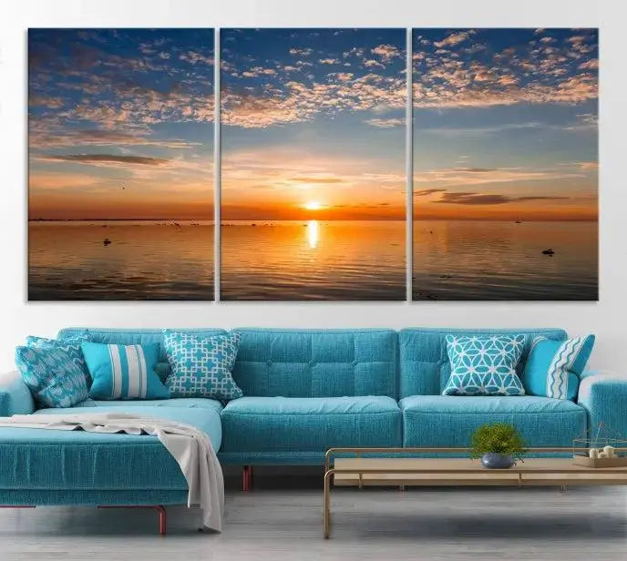 The "Sunset on the Sea Wall Art Canvas Print" graces the space as a stunning triptych, with its museum-quality canvas showcasing a serene sunset over water. The gallery-wrapped edges enhance depth and elegance, creating an ideal centerpiece for any room.