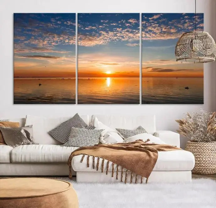 The "Sunset on the Sea Wall Art Canvas Print" graces the space as a stunning triptych, with its museum-quality canvas showcasing a serene sunset over water. The gallery-wrapped edges enhance depth and elegance, creating an ideal centerpiece for any room.