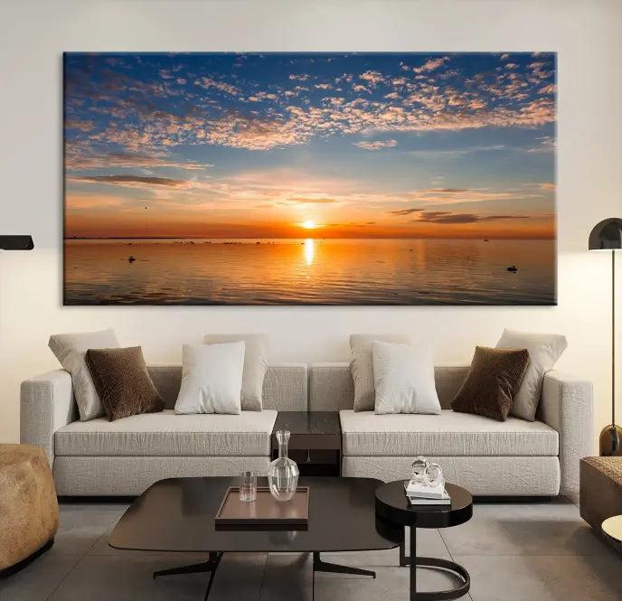 The "Sunset on the Sea Wall Art Canvas Print" graces the space as a stunning triptych, with its museum-quality canvas showcasing a serene sunset over water. The gallery-wrapped edges enhance depth and elegance, creating an ideal centerpiece for any room.