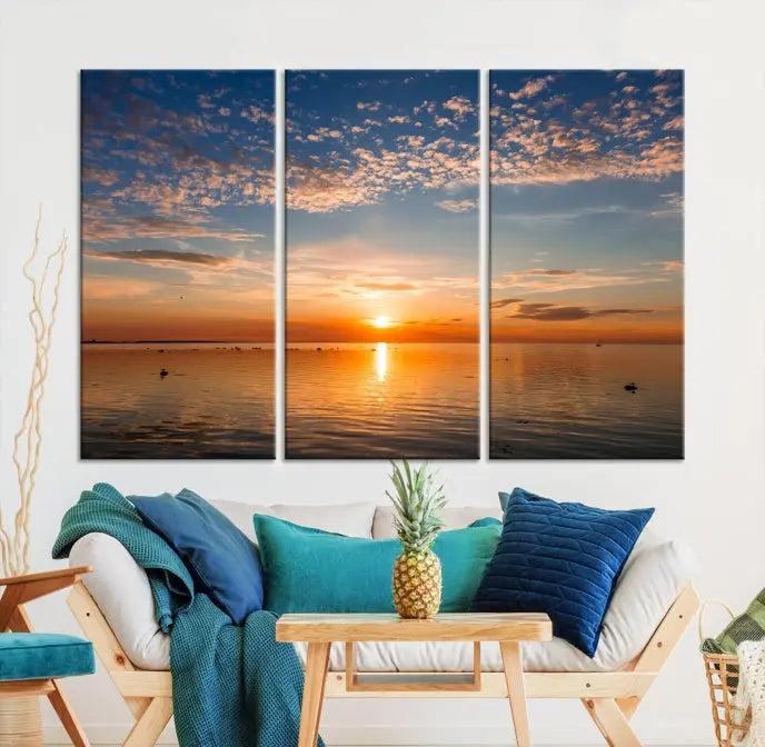 The "Sunset on the Sea Wall Art Canvas Print" graces the space as a stunning triptych, with its museum-quality canvas showcasing a serene sunset over water. The gallery-wrapped edges enhance depth and elegance, creating an ideal centerpiece for any room.