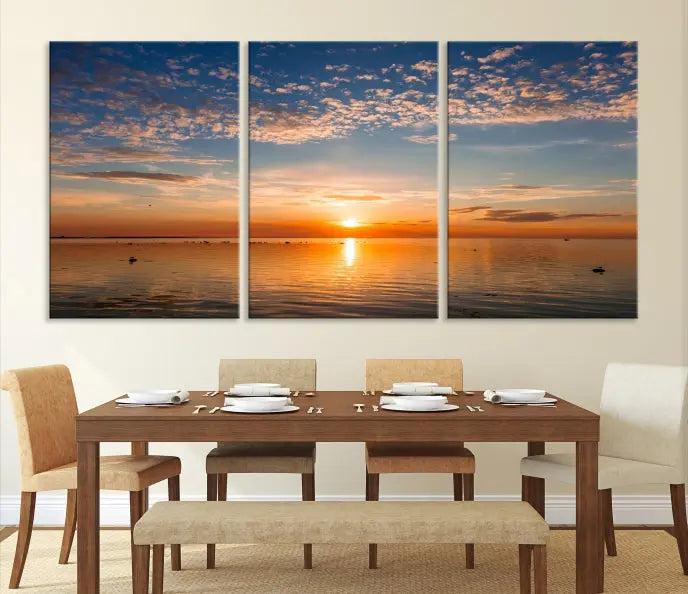 The "Sunset on the Sea Wall Art Canvas Print" graces the space as a stunning triptych, with its museum-quality canvas showcasing a serene sunset over water. The gallery-wrapped edges enhance depth and elegance, creating an ideal centerpiece for any room.