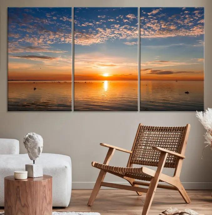 The "Sunset on the Sea Wall Art Canvas Print" graces the space as a stunning triptych, with its museum-quality canvas showcasing a serene sunset over water. The gallery-wrapped edges enhance depth and elegance, creating an ideal centerpiece for any room.