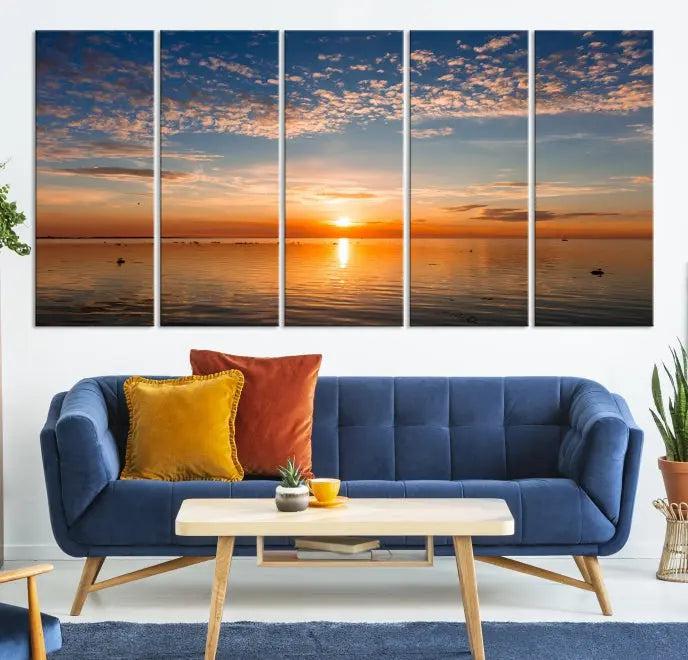 The "Sunset on the Sea Wall Art Canvas Print" graces the space as a stunning triptych, with its museum-quality canvas showcasing a serene sunset over water. The gallery-wrapped edges enhance depth and elegance, creating an ideal centerpiece for any room.