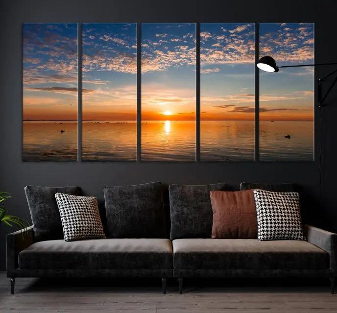 The "Sunset on the Sea Wall Art Canvas Print" graces the space as a stunning triptych, with its museum-quality canvas showcasing a serene sunset over water. The gallery-wrapped edges enhance depth and elegance, creating an ideal centerpiece for any room.