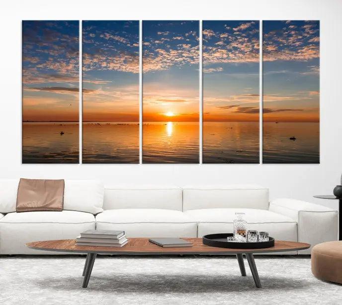 The "Sunset on the Sea Wall Art Canvas Print" graces the space as a stunning triptych, with its museum-quality canvas showcasing a serene sunset over water. The gallery-wrapped edges enhance depth and elegance, creating an ideal centerpiece for any room.