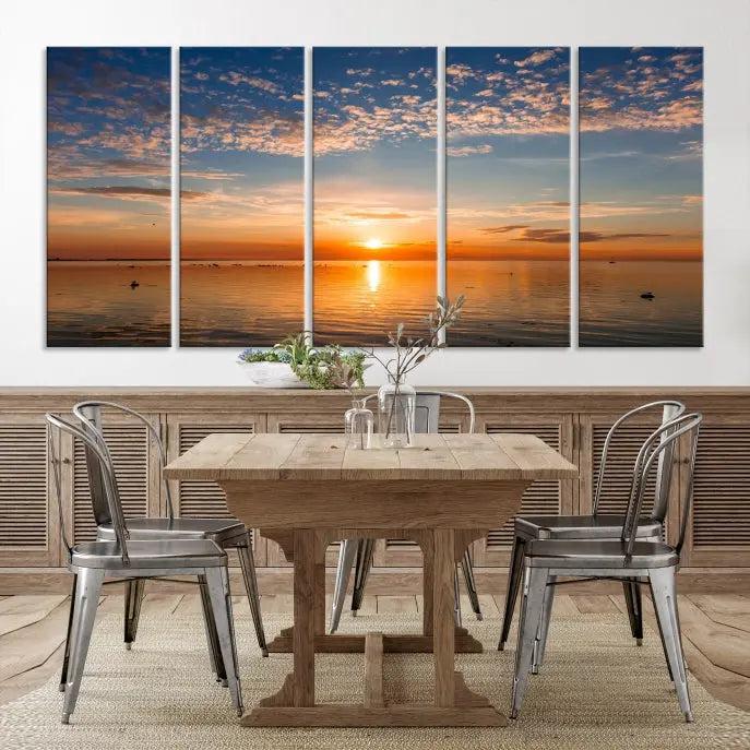 The "Sunset on the Sea Wall Art Canvas Print" graces the space as a stunning triptych, with its museum-quality canvas showcasing a serene sunset over water. The gallery-wrapped edges enhance depth and elegance, creating an ideal centerpiece for any room.