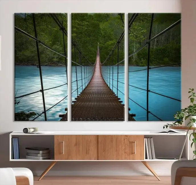 A breathtaking 3-panel nature photography piece titled "Suspension Bridge Over River Canvas Art" beautifully enhances the living room wall, adding an exquisite touch of scenic wall art.