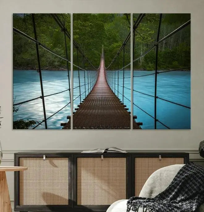 A breathtaking 3-panel nature photography piece titled "Suspension Bridge Over River Canvas Art" beautifully enhances the living room wall, adding an exquisite touch of scenic wall art.