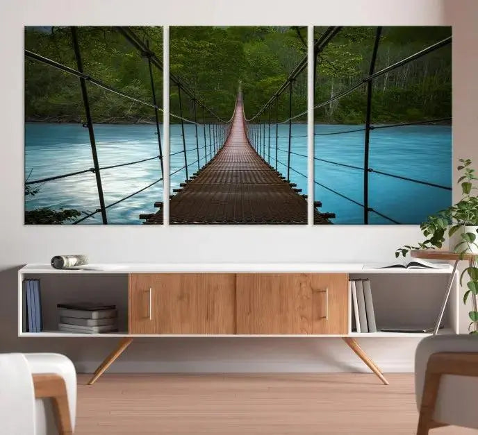 A breathtaking 3-panel nature photography piece titled "Suspension Bridge Over River Canvas Art" beautifully enhances the living room wall, adding an exquisite touch of scenic wall art.