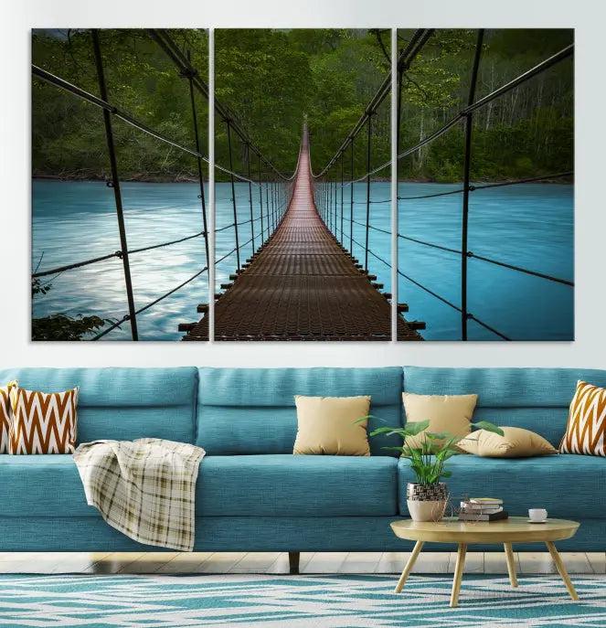 A breathtaking 3-panel nature photography piece titled "Suspension Bridge Over River Canvas Art" beautifully enhances the living room wall, adding an exquisite touch of scenic wall art.