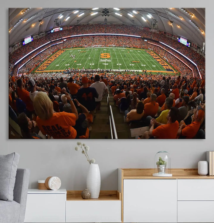 The Syracuse University Orange Football Team Print is a canvas wall art of the Syracuse JMA Wireless Dome, beautifully resembling a packed stadium with fans in orange and capturing the energy of the moment with a gallery-quality finish.