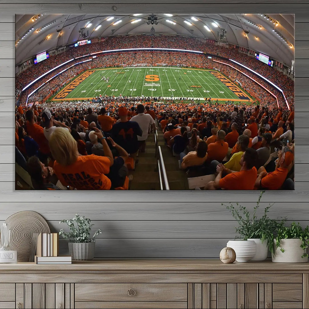 The Syracuse University Orange Football Team Print is a canvas wall art of the Syracuse JMA Wireless Dome, beautifully resembling a packed stadium with fans in orange and capturing the energy of the moment with a gallery-quality finish.