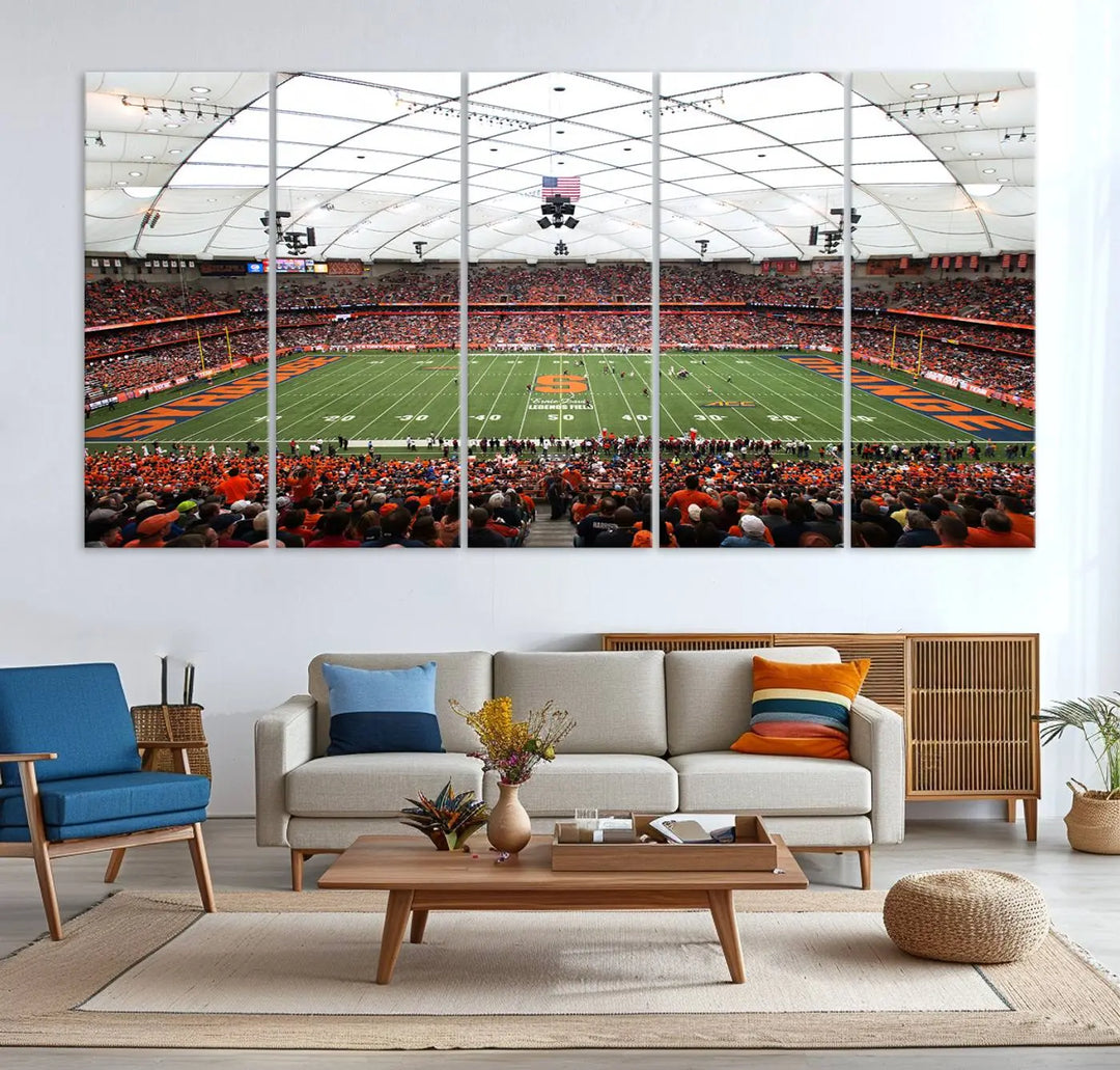 The living room boasts a sizable, three-panel canvas artwork on the wall, depicting the vibrant crowd of the Syracuse University Orange football team at Syracuse JMA Wireless Dome, complete with a gallery-quality finish.